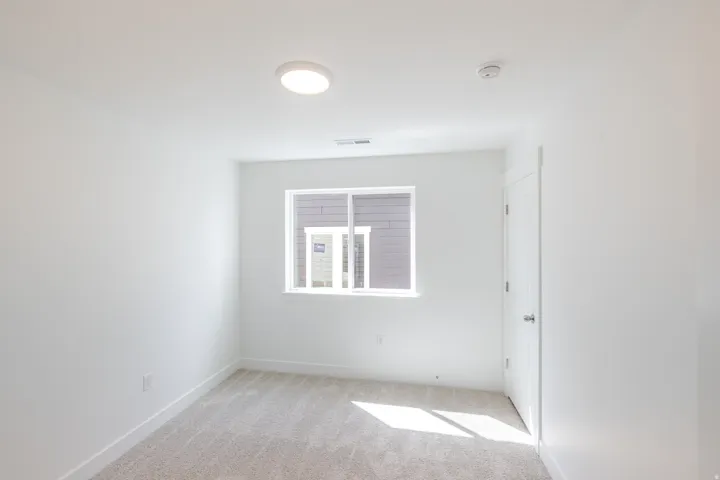 Neutral carpet flooring and white painted walls