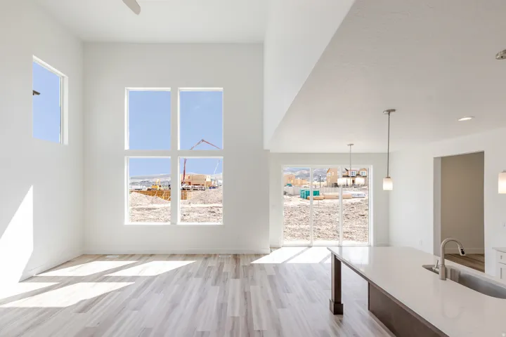 Vaulted ceilings, wood-finish flooring, and expansive windows
