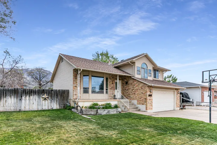 Traditional two-story home featuring a brick and siding exterior