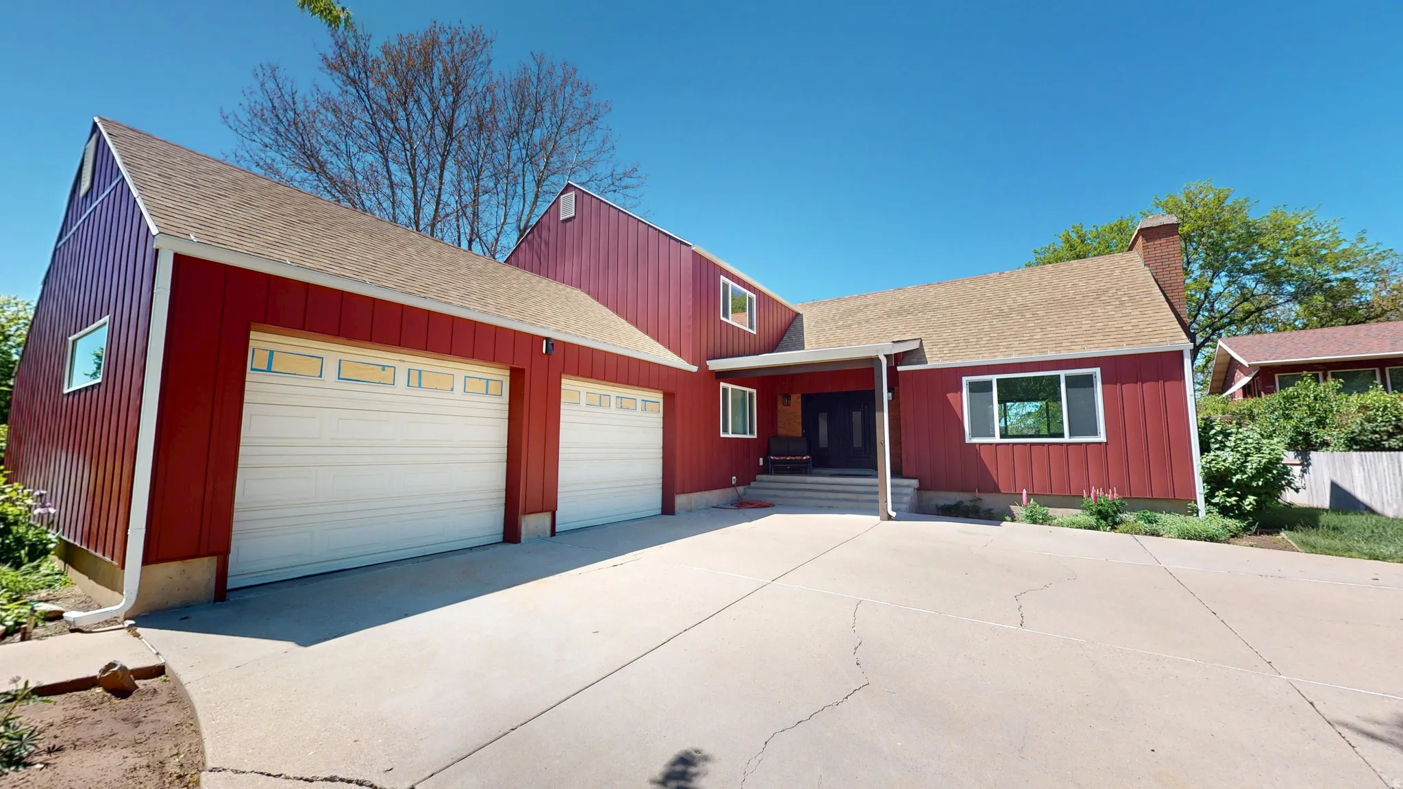 Red vertical siding exterior with a light brown shingle roof