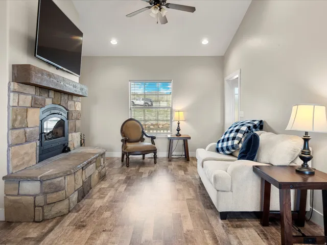 Stone fireplace with hearth seating and wood mantel