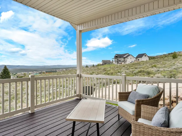 Covered outdoor deck with dark composite decking and a light-colored railing