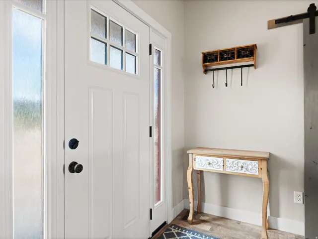 Entryway featuring a white paneled door with glass inserts and a frosted sidelight