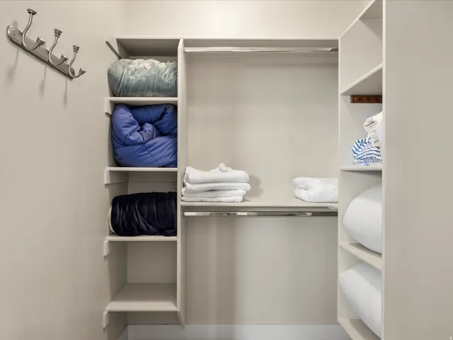 Built-in closet system featuring multiple shelves and hanging rods