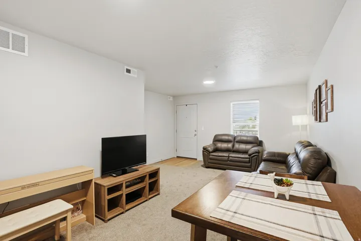 Living area featuring light neutral wall paint and carpet flooring
