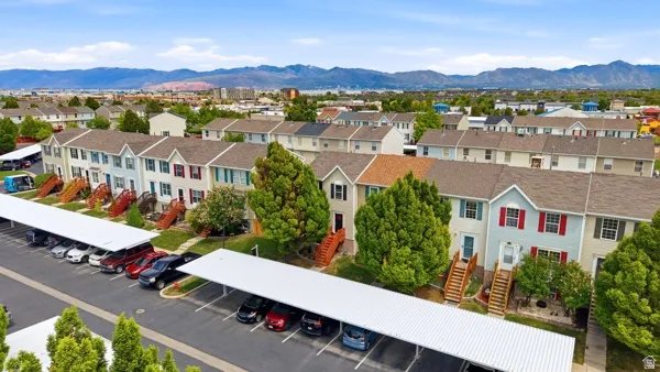 Townhome community featuring multi-level residences with light-colored siding and dark shingled roofs