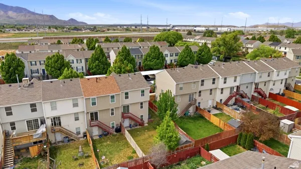 Two-story townhouse with private fenced yard, elevated deck, and lower patio access