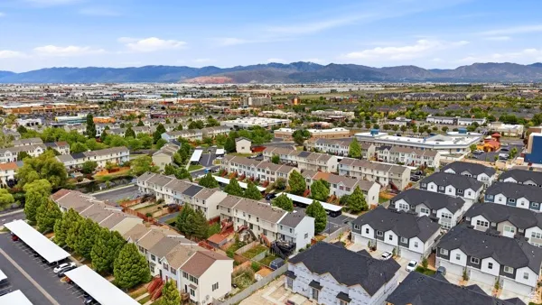 Expansive aerial perspective showcasing a residential community with distant mountain ranges