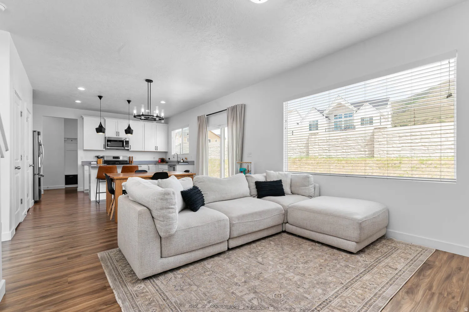 Open-concept living space featuring wood-finish flooring