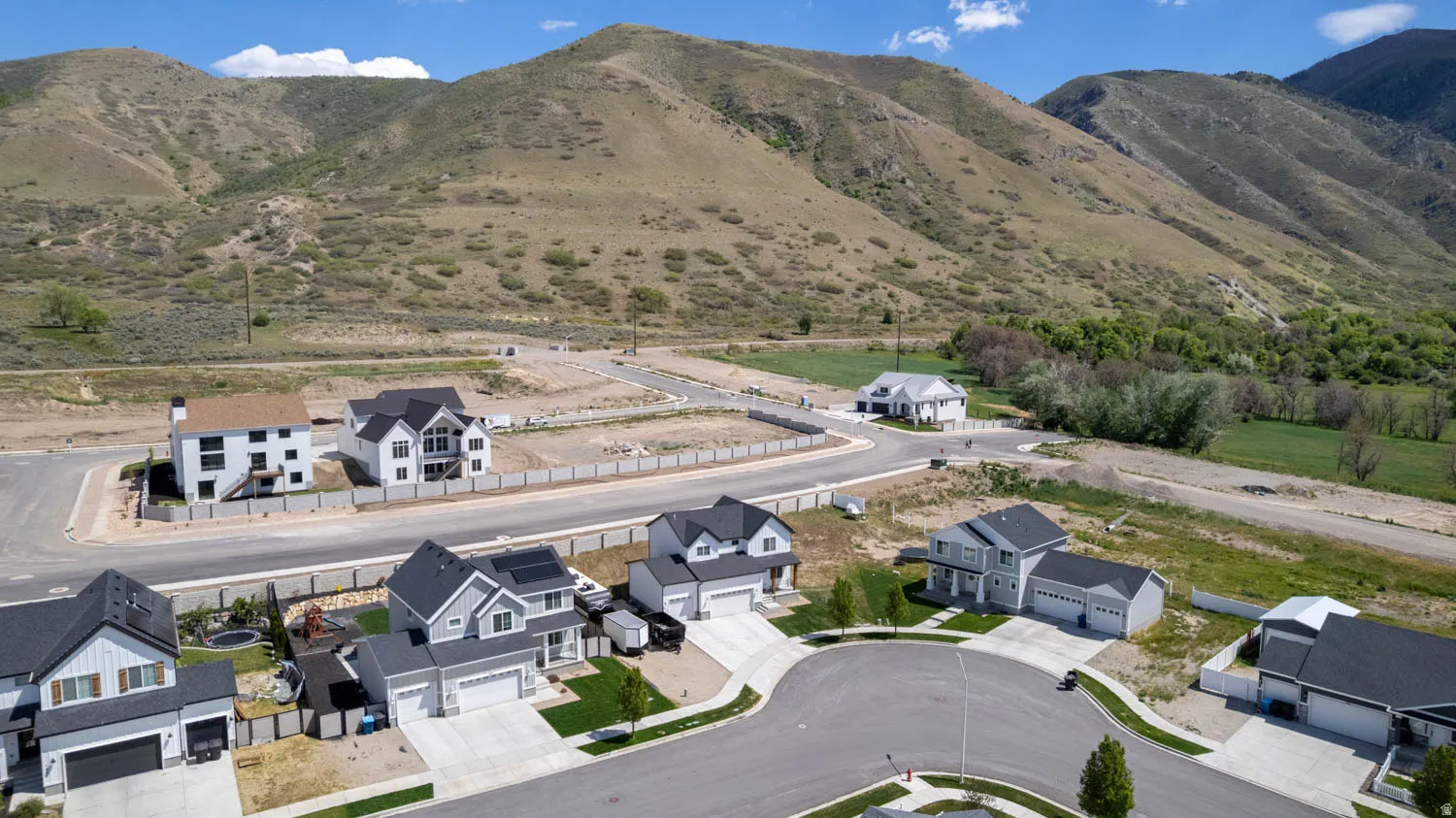 Modern residential development nestled against a prominent mountain backdrop