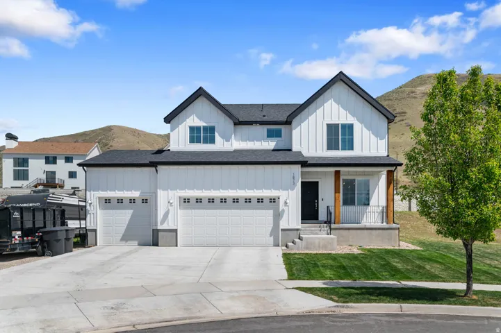 Contemporary farmhouse exterior with white board and batten siding