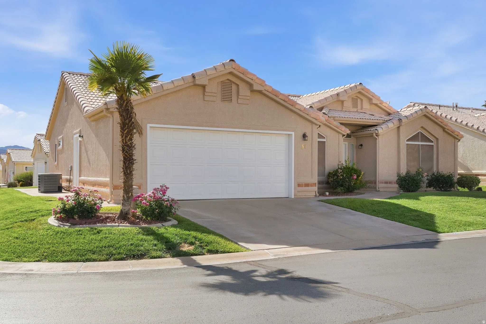 Tiled roof residence with an attached two-car garage