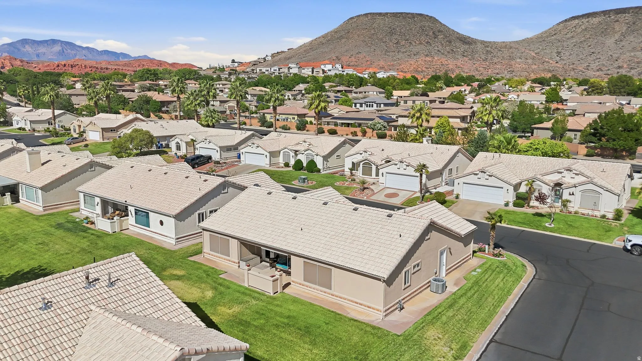 Aerial perspective showcasing a residential community with red rock mountain backdrops
