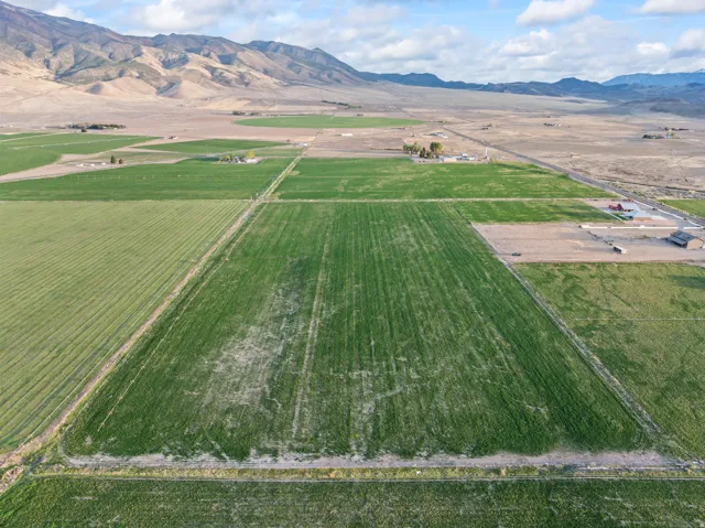 Expansive agricultural property featuring multiple cultivated fields and visible irrigation channels