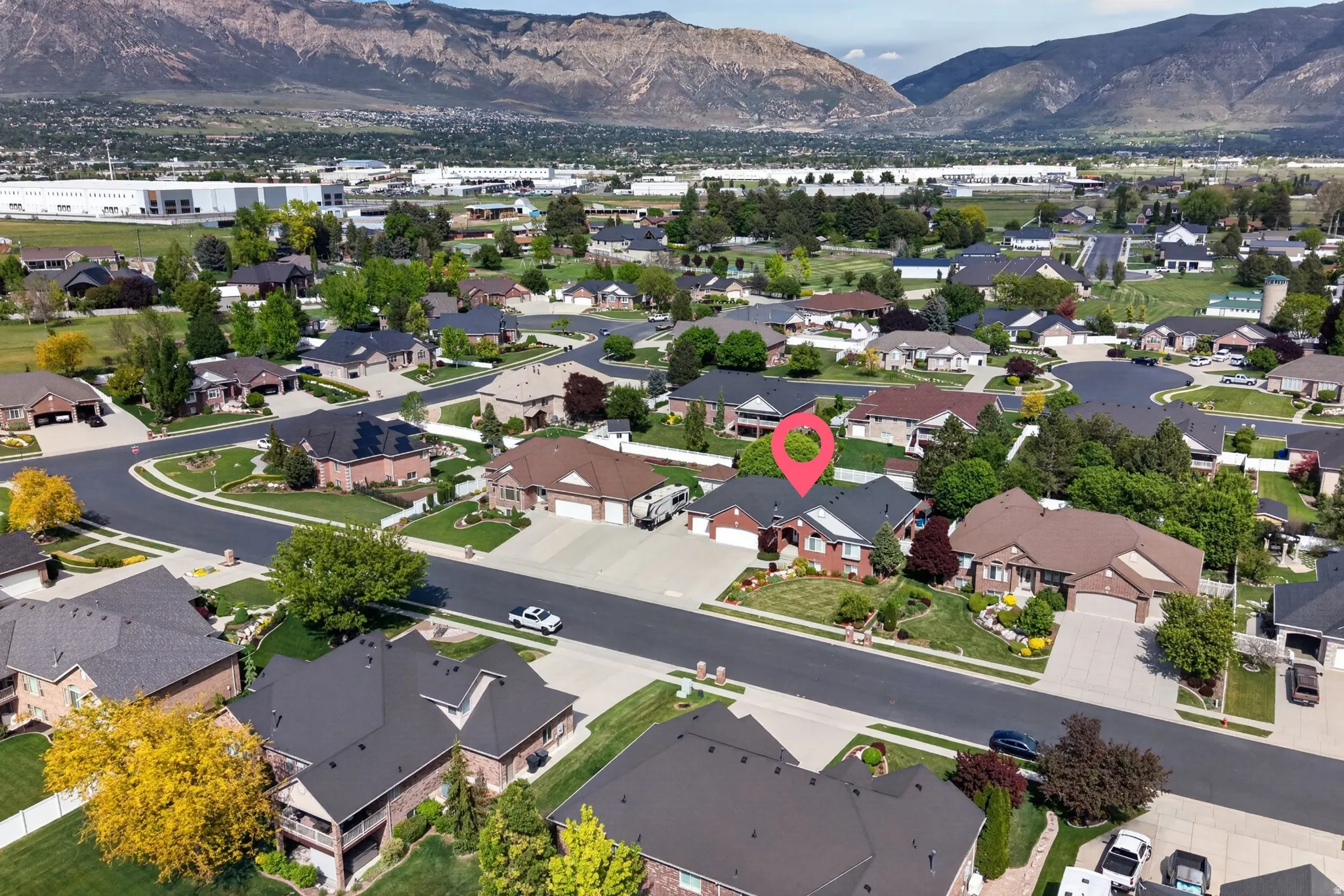 Residential neighborhood featuring mature trees and mountain backdrops