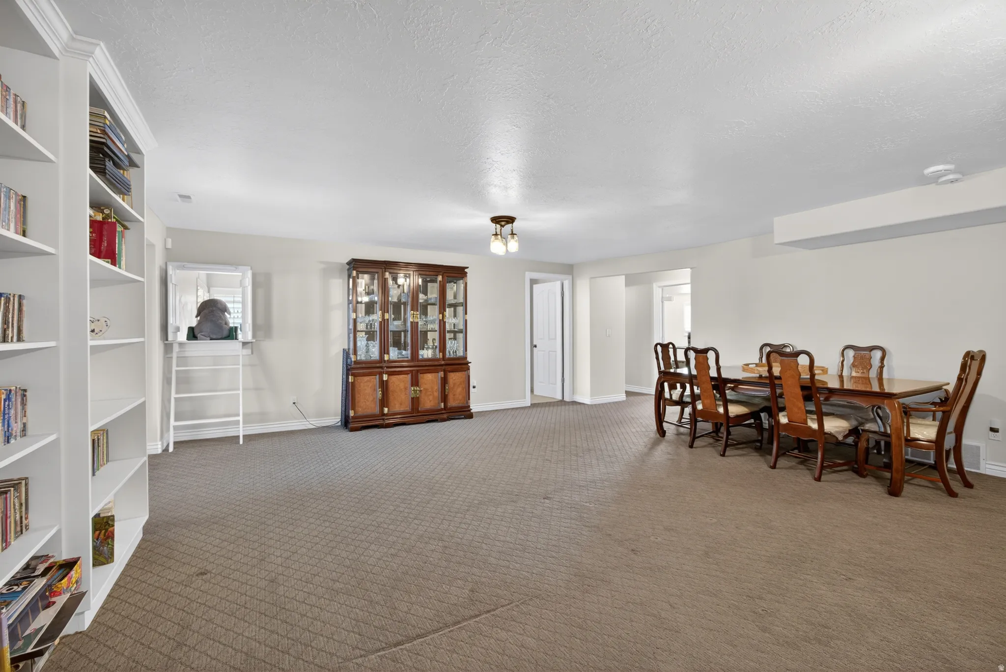 Expansive room featuring wall-to-wall carpeting and neutral-toned painted walls
