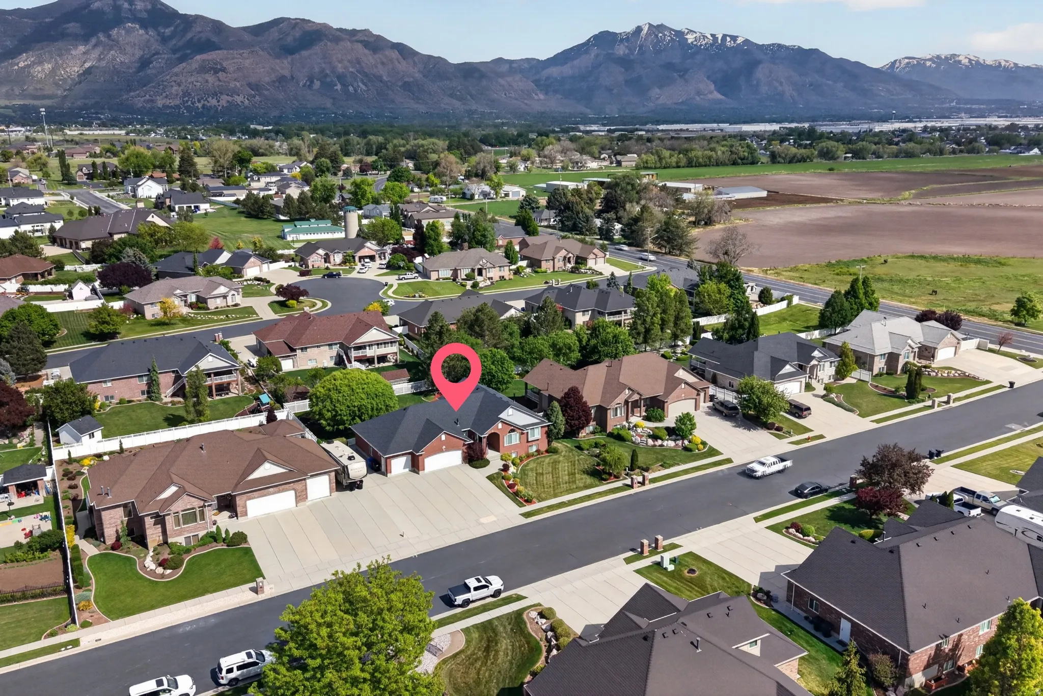 Aerial perspective showcasing a residential neighborhood with mountain scenery
