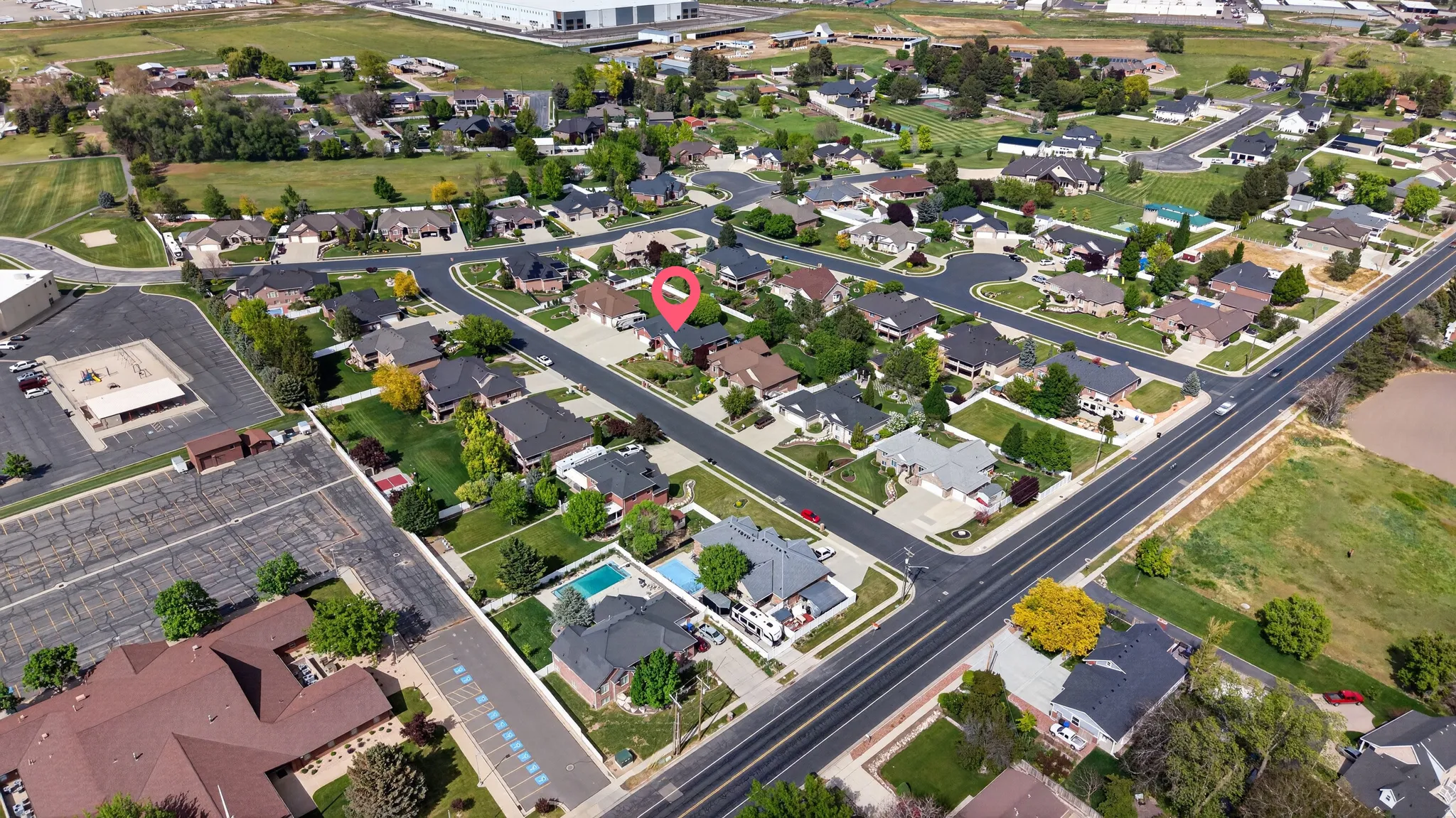 Residential community featuring paved streets, mature landscaping, and varied architectural styles