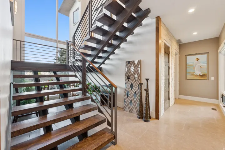 Open riser staircase with wood-finish treads and metal railing