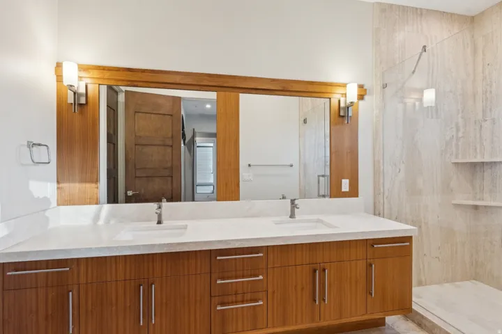 Dual vanity with a light-toned countertop and integrated sinks