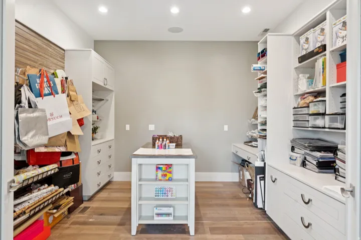 Dedicated room featuring wood-finish flooring and extensive built-in cabinetry
