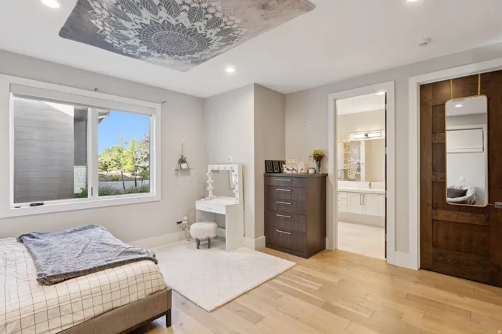 Spacious room featuring light wood-finish flooring, a large window, and recessed lighting