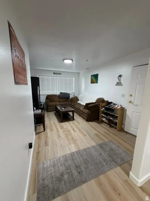Open concept living space featuring wood-finish flooring