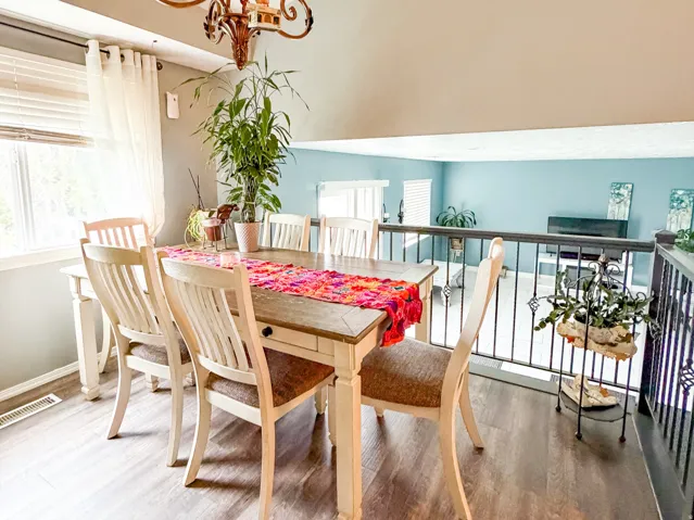Dining area featuring a decorative chandelier and wood-finish flooring