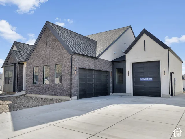 Modern exterior featuring a dark brick facade and stucco accents