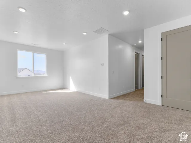 Recessed lighting, light-toned walls, and a window with a mountain backdrop