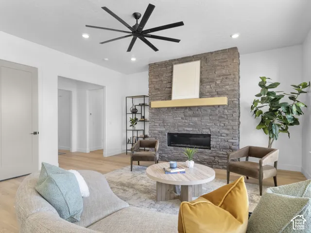 Stone-clad fireplace with a wood mantel and linear firebox