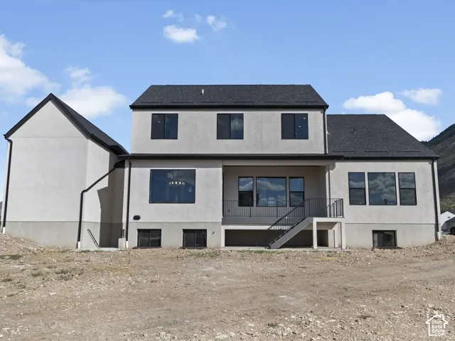 Two-story exterior with a covered patio and an exterior staircase