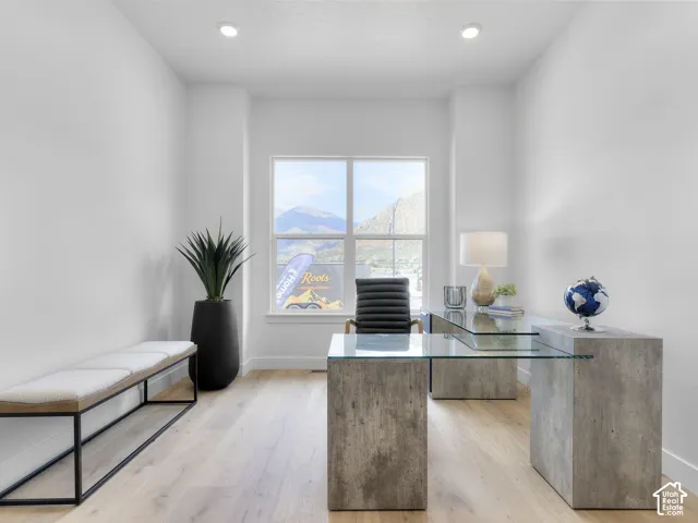 Recessed ceiling lighting, light wood-finish flooring, and a large window