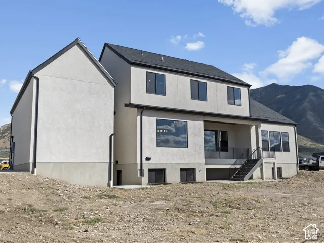 Contemporary exterior with light-toned stucco and dark-framed windows