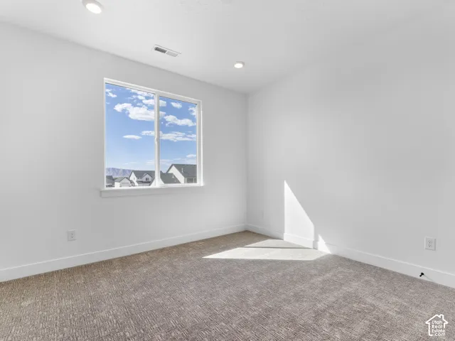 Wall-to-wall carpeting and white painted walls