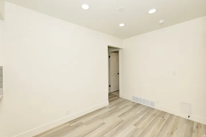 Light wood-finish flooring extending into the room