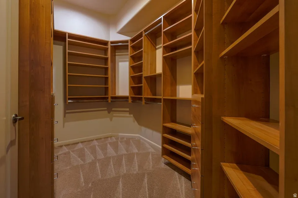 Custom wood-finish shelving system with integrated drawers and hanging rods