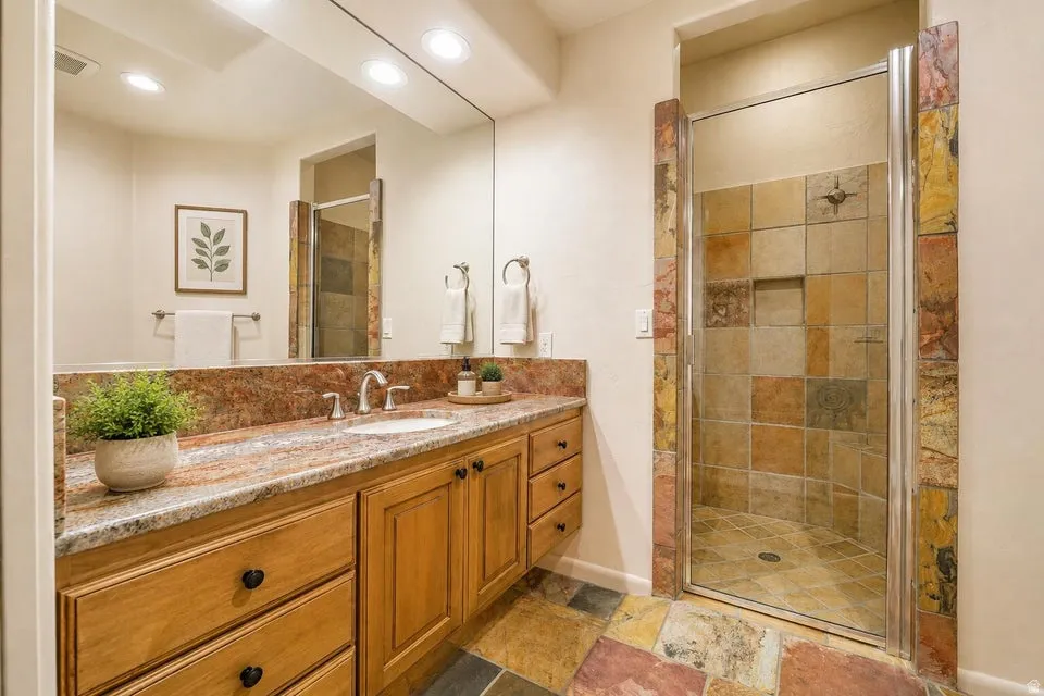 Wood-finish vanity with a built-in sink and stone countertop