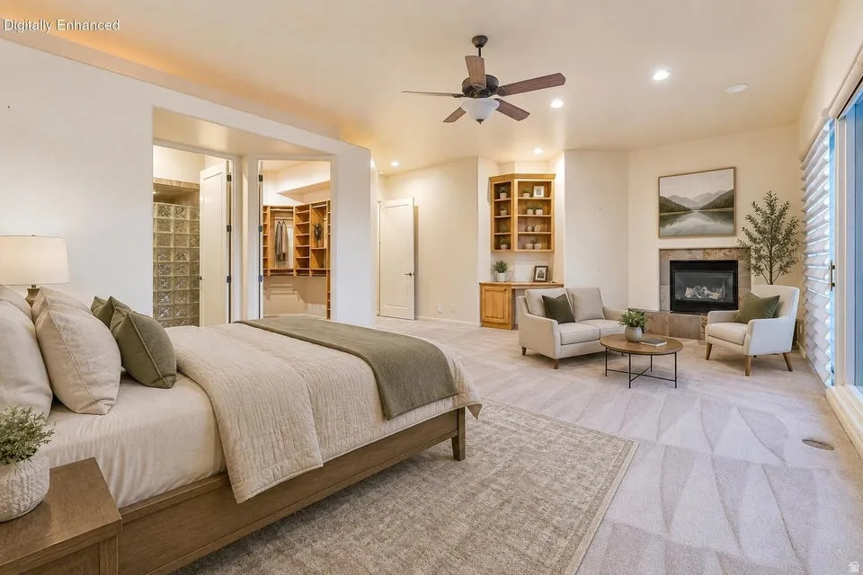 Spacious room with a built-in corner fireplace, wood-finish built-in shelving, glass block wall, and ceiling fan