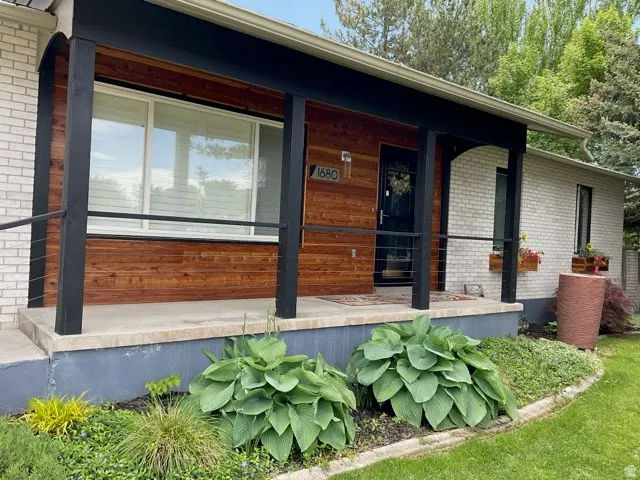 Front exterior featuring white brick and redwood accents