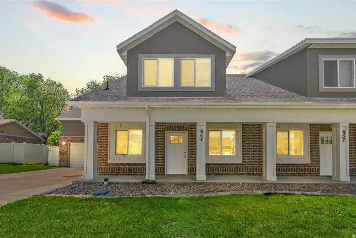 Modern townhome exterior featuring brick and stucco siding