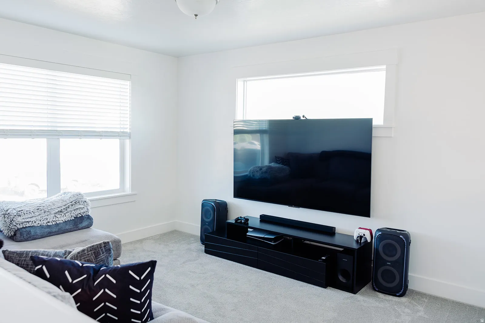 Bright room featuring light gray carpeting and white walls