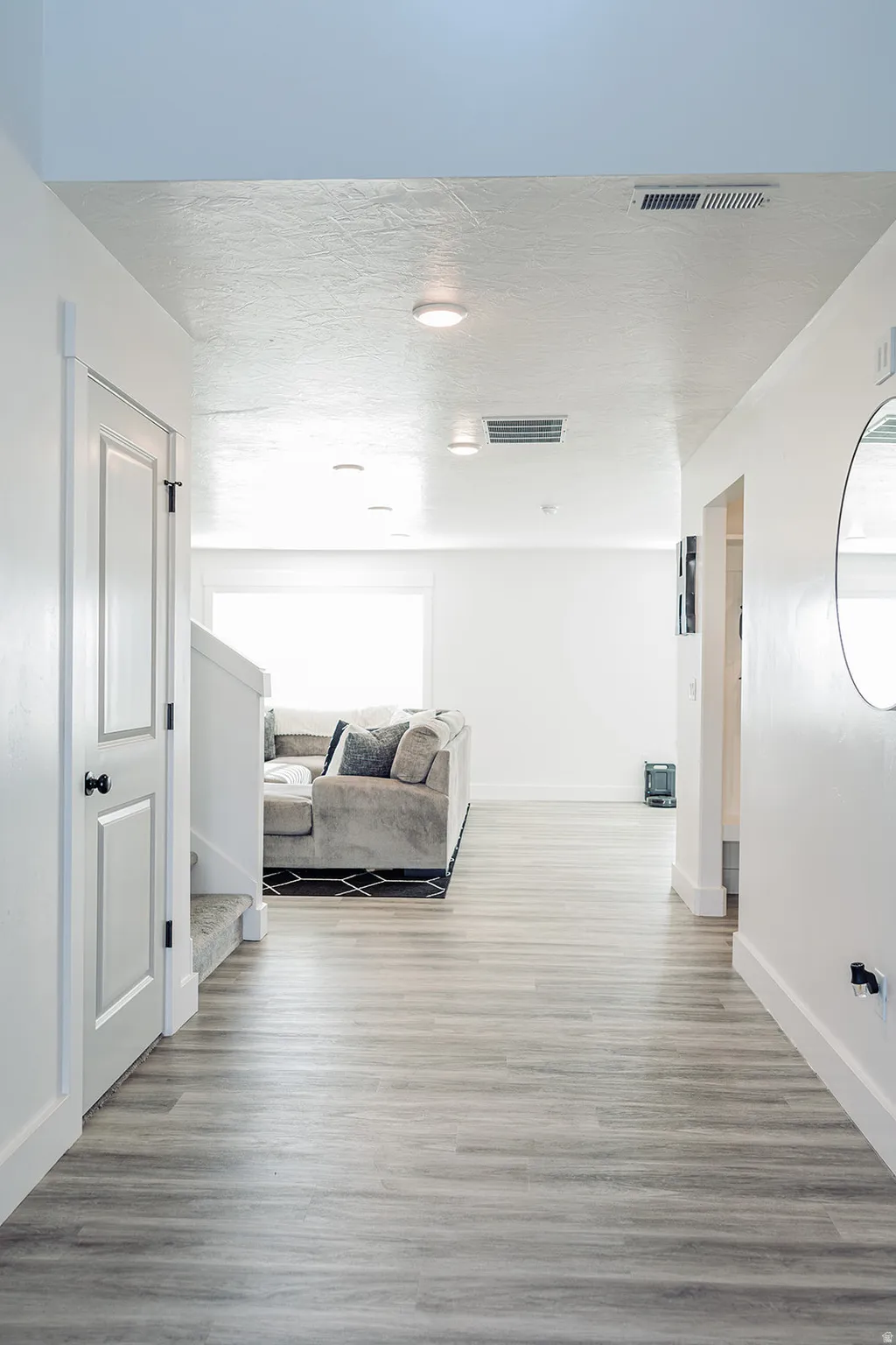 Entryway featuring wood-finish flooring and white baseboards