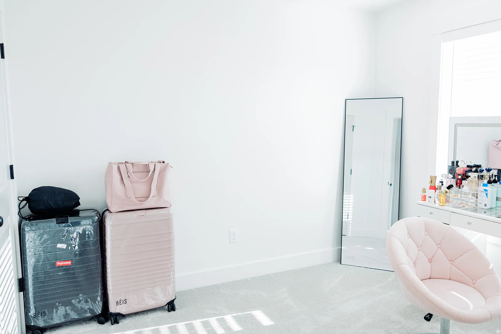 Bright interior space featuring white walls and a large window with blinds