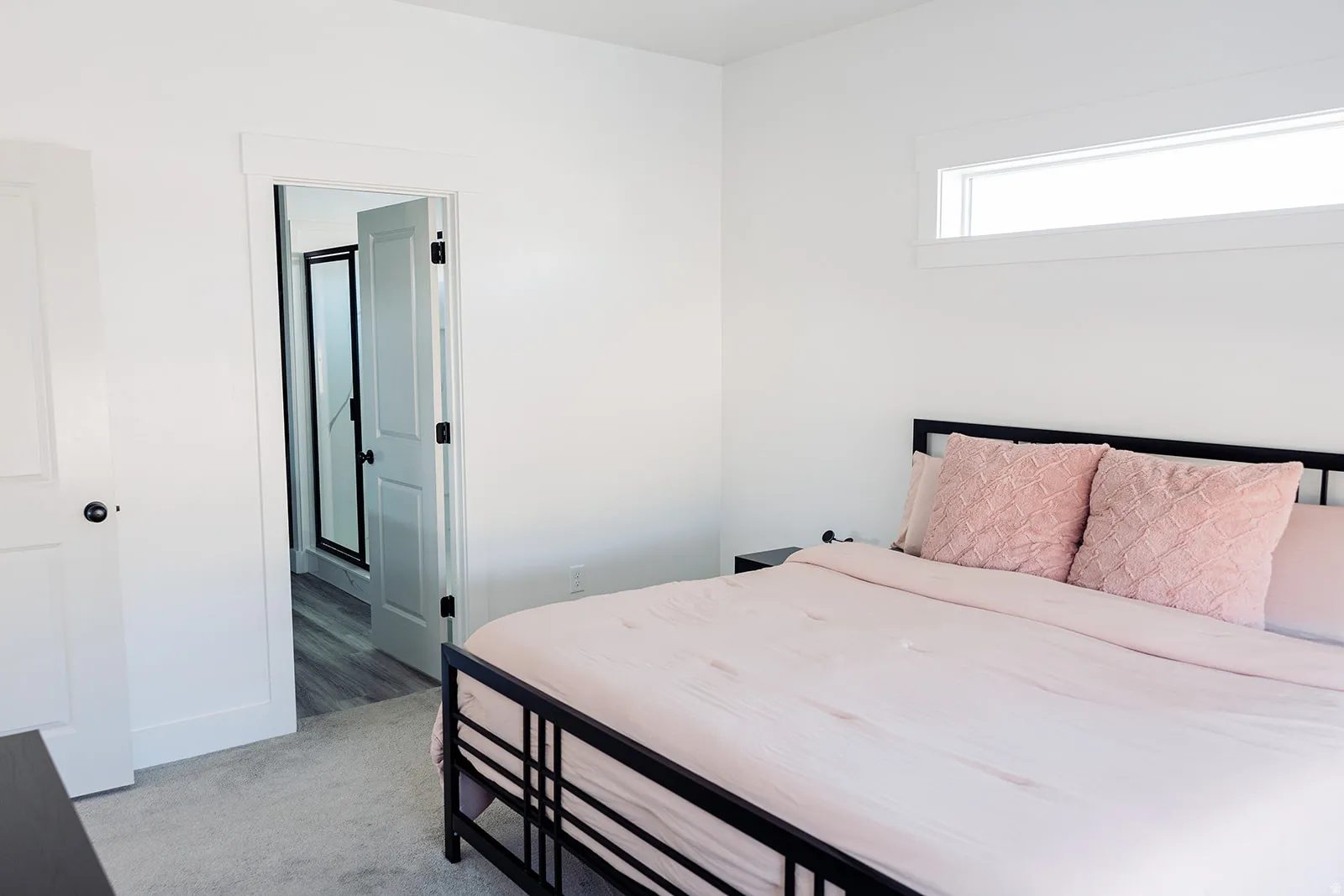 White interior walls featuring a horizontal transom window