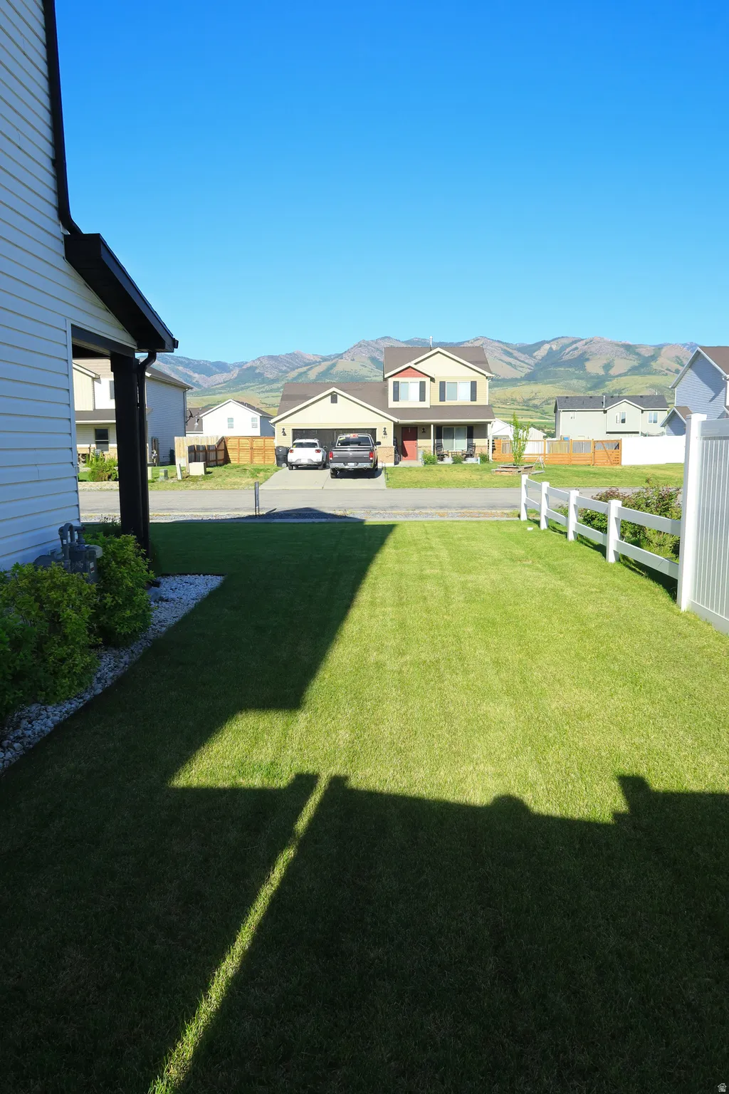 Lush green lawn with white picket fencing