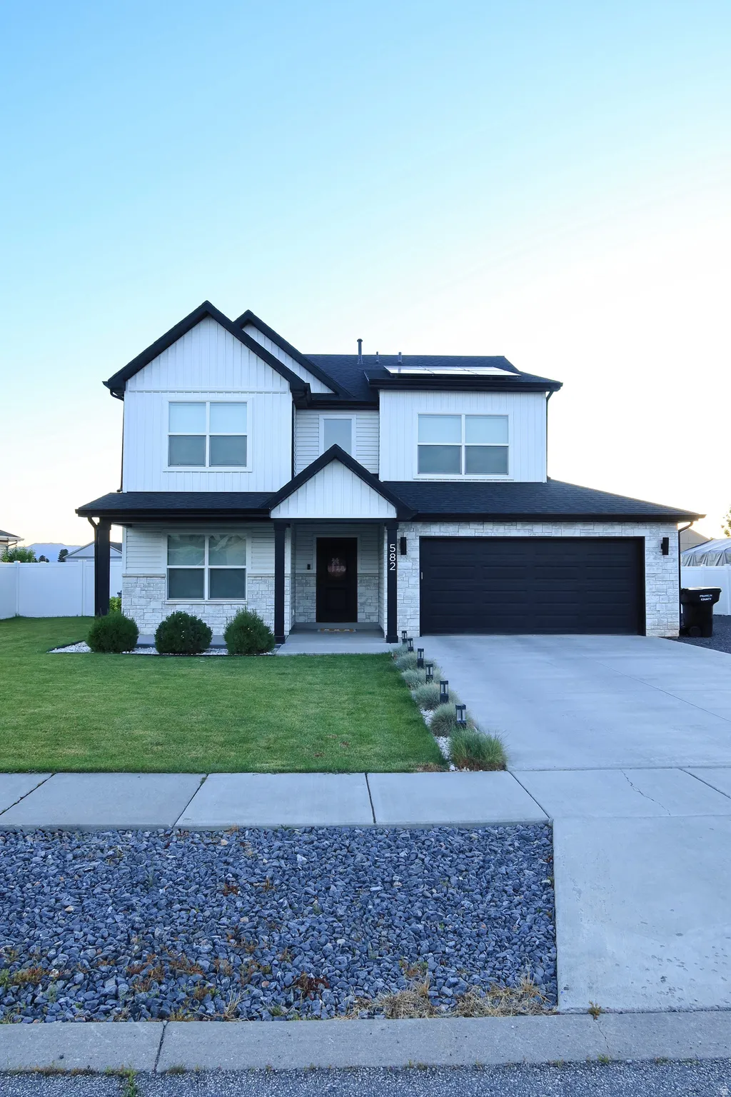 Two-story exterior with dark trim and white siding