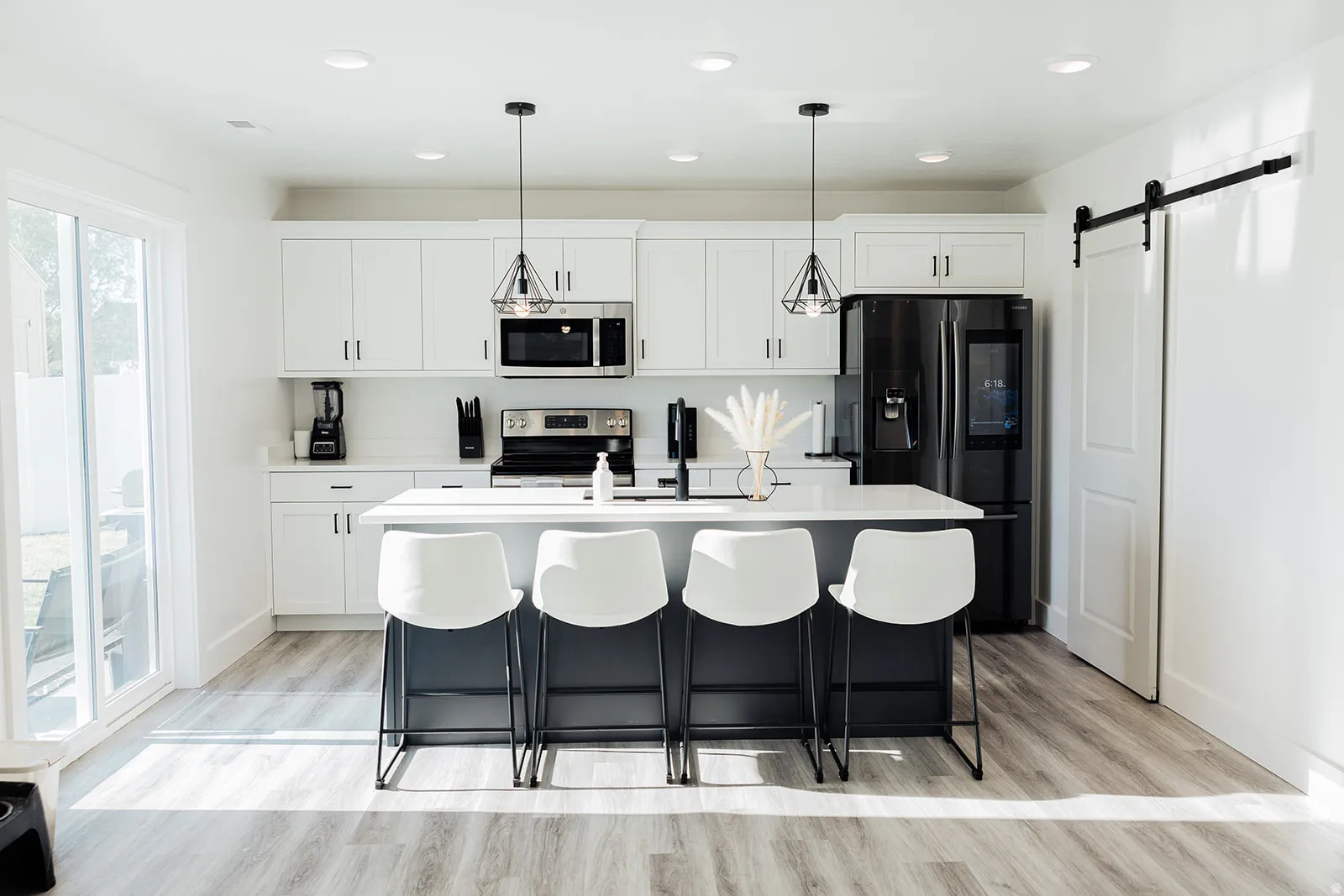 Kitchen with a central island featuring a light-colored countertop and dark base cabinetry