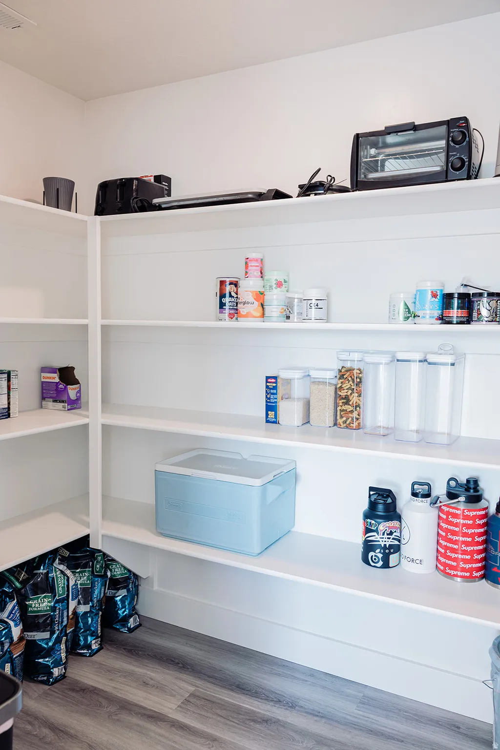 Custom built-in pantry shelving provides ample storage