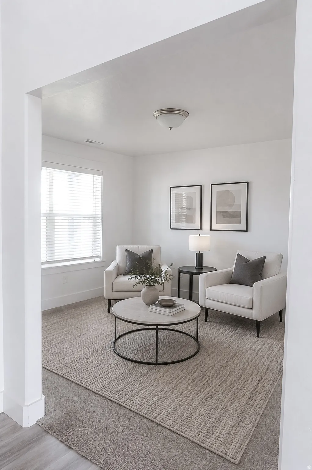 Recessed lighting, wood-finish flooring, and white interior walls